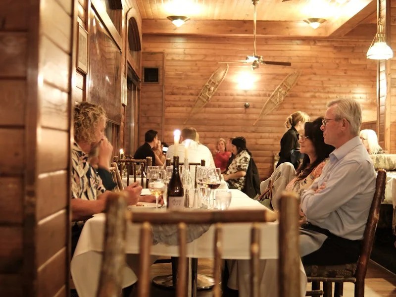 Guests dining lake side